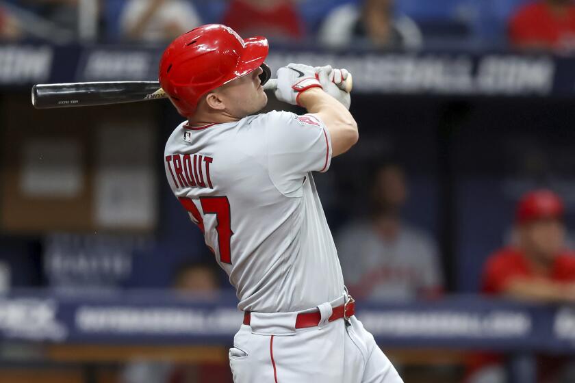Los Angeles Angels' Mike Trout follows through on a home run against the Tampa Bay Rays during the sixth inning of a baseball game Tuesday, Aug. 23, 2022, in St. Petersburg, Fla. (AP Photo/Mike Carlson)