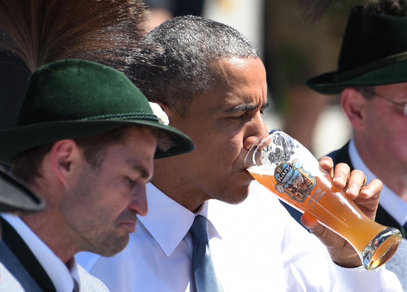 President Obama drinks beer at a meeting with German Chancellor Angela Merkel and local residents in Kruen on June 7.