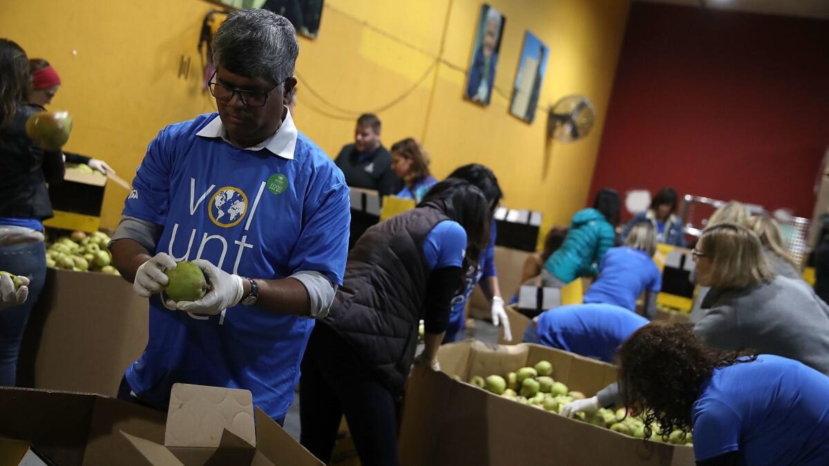 Volunteers sort pears at the SF-Marin Food Bank on Nov. 28, in San Francisco.