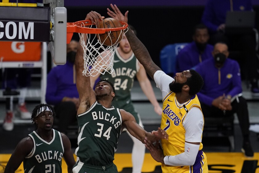 Milwaukee Bucks forward Giannis Antetokounmpo (34) dunks against Los Angeles Lakers center Andre Drummond (2) during the second quarter of an NBA basketball game Wednesday, March 31, 2021, in Los Angeles. (AP Photo/Ashley Landis)