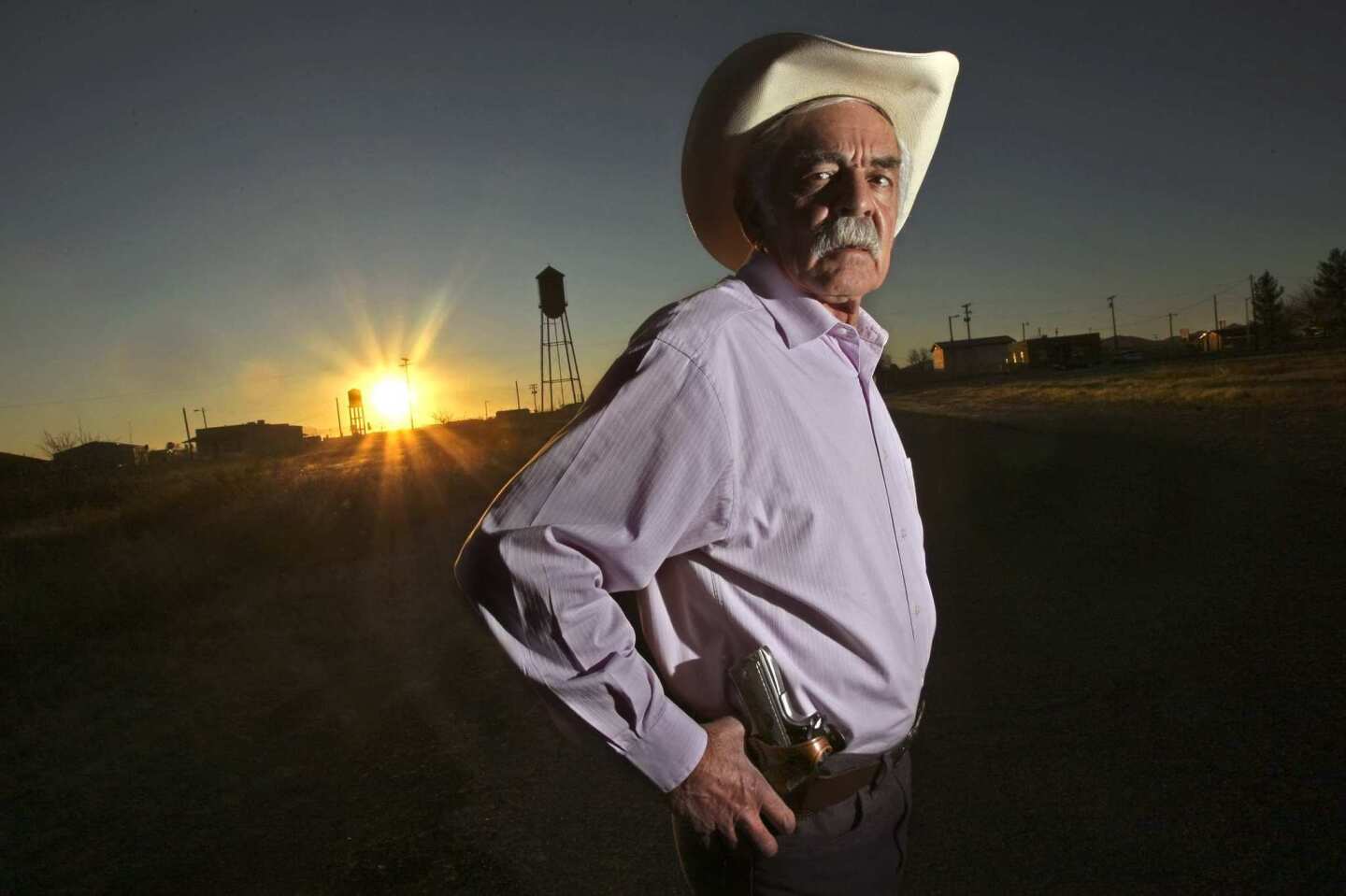 Javier Lozano is the pistol-packing municipal judge in Columbus, N.M., where the mayor, police chief and a city trustee pleaded guilty in a scheme to smuggle guns across the nearby U.S.-Mexico border. If Mexican cartel violence isn't stopped, he said, more U.S. communities are likely to experience similar disgraces