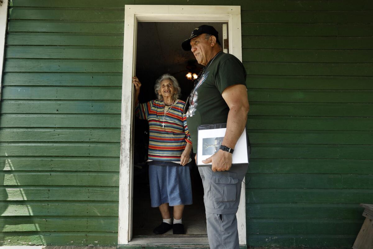 Chief Albert Naquin visits Oxcelia Naquin, who lives on the island with her husband.