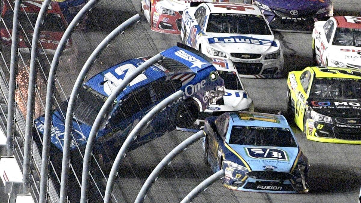Eventual race winner Ricky Stenhouse Jr. guides his No. 17 car underneath the airborne car of Kyle Larson during the Coke Zero 400 on Saturday night at Daytona International Speedway.