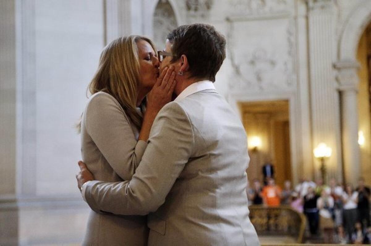 Sandy Stier, left, and Kris Perry share a long-awaited wedding kiss.