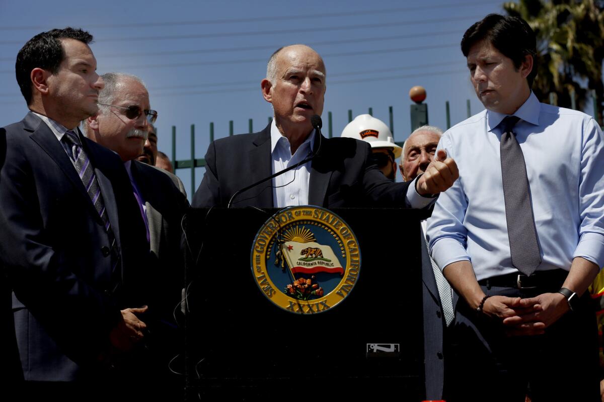 Assembly Speaker Anthony Rendon, left, Gov. Jerry Brown and Senate President Pro Tem Kevin de León appear in Riverside in April to call for gas tax hike. All three are getting raises.