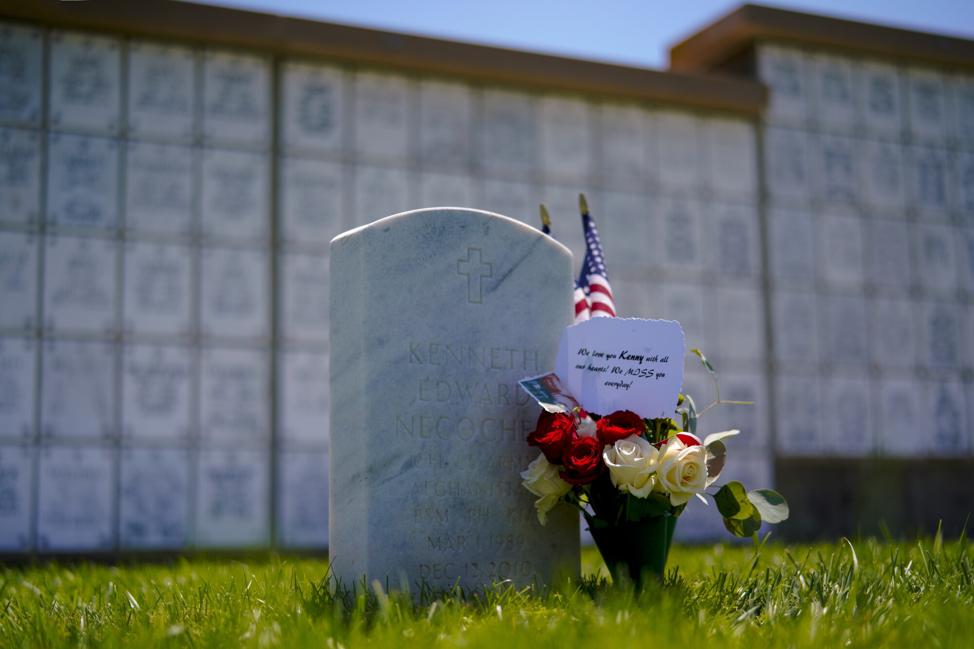 A headstone and a bouquet of roses