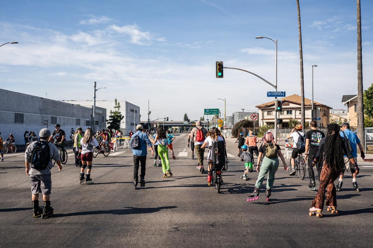 People walk in a street during a CicLAvia event.