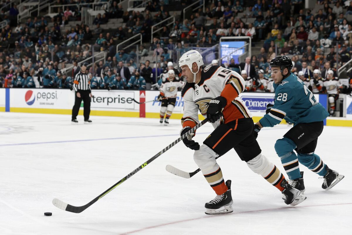 Ducks center Ryan Getzlaf (15) handles the puck as San Jose Sharks right wing Timo Meier (28) defends March 26, 2022.