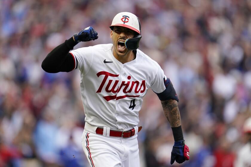 Minnesota Twins' Carlos Correa reacts after hitting an RBI single during the fourth inning of Game 2 of an AL wild-card baseball playoff series against the Toronto Blue Jays Wednesday, Oct. 4, 2023, in Minneapolis. (AP Photo/Abbie Parr)