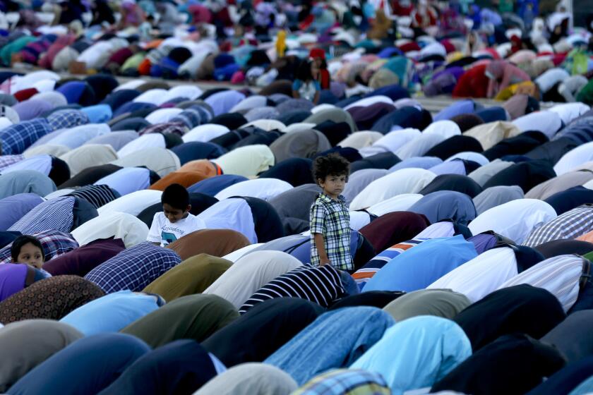 Orange County Muslims gather in prayer in the parking lot of Angel Stadium in Anaheim for Eid al-Adha to mark the end of the annual pilgrimage to Mecca known as Hajj on Sept. 23.