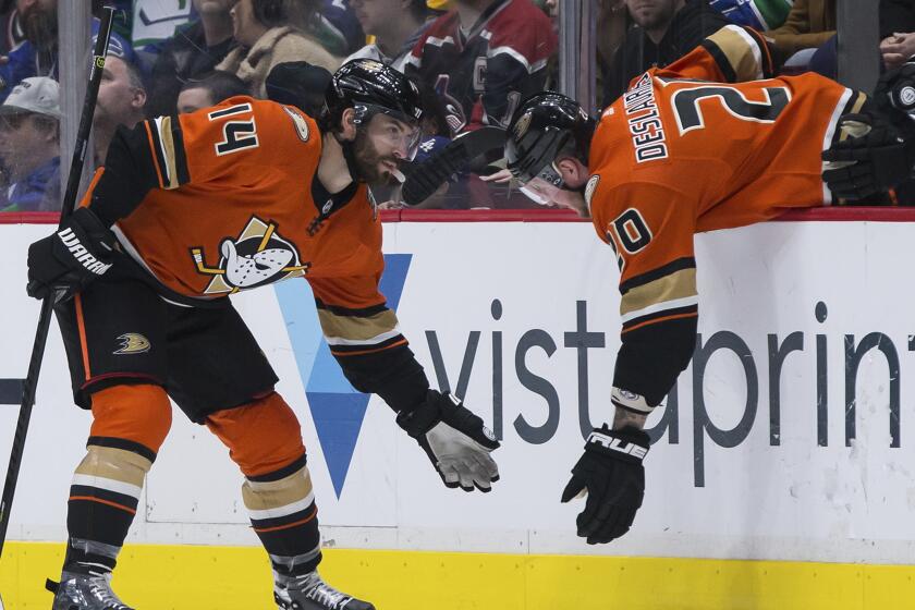 Anaheim Ducks' Adam Henrique, left, celebrates his goal against the Vancouver Canucks with Nicolas Deslauriers during the second period of an NHL hockey game Sunday, Feb. 16, 2020, in Vancouver, British Columbia. (Darryl Dyck/The Canadian Press via AP)
