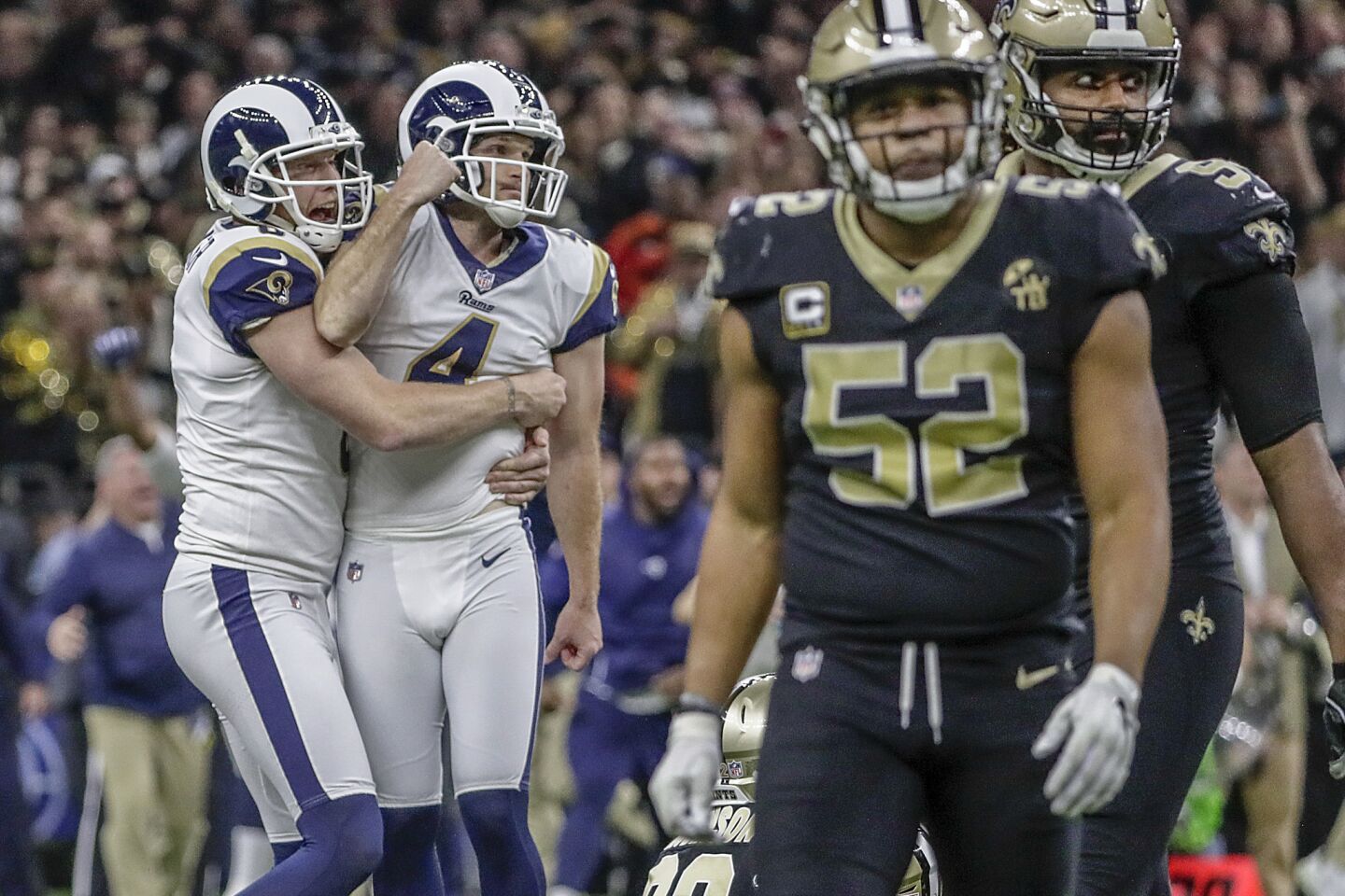 Rams kicker Greg Zuerlein is lifted by teammate Johnny Hekker after hitting a 57-yard field goal in overtime to beat the New Orleans Saints 26-23 in the NFC Championship at the Superdome.