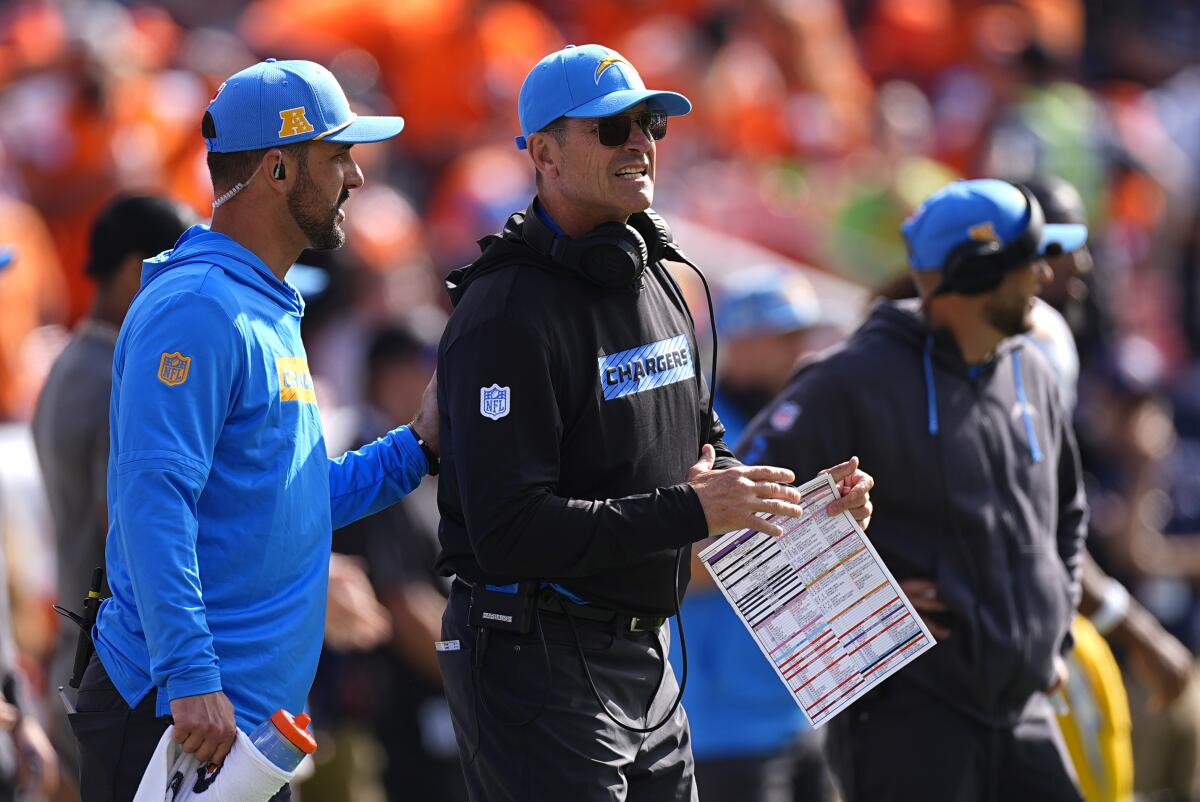 Chargers coach Jim Harbaugh, center, stands on the sideline during the first half against the Denver Broncos on Oct. 13.