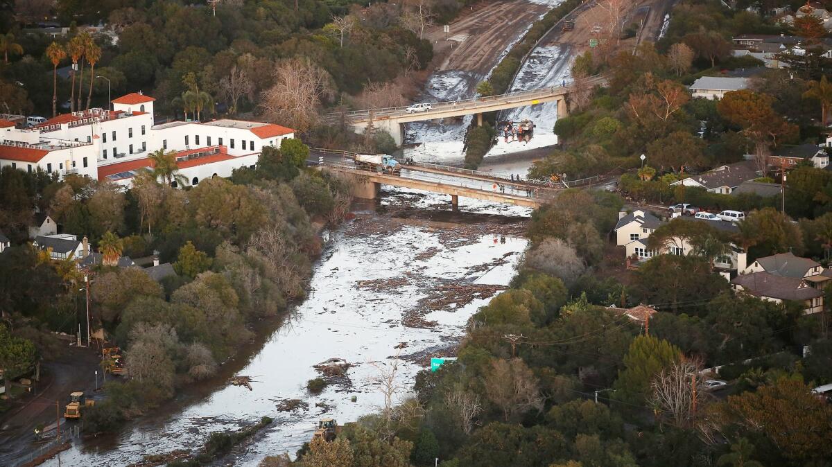 The 101 Freeway is closed on Jan. 11 as mud and debris clog the roadway at the Olive Mill Road overpass in Montecito.