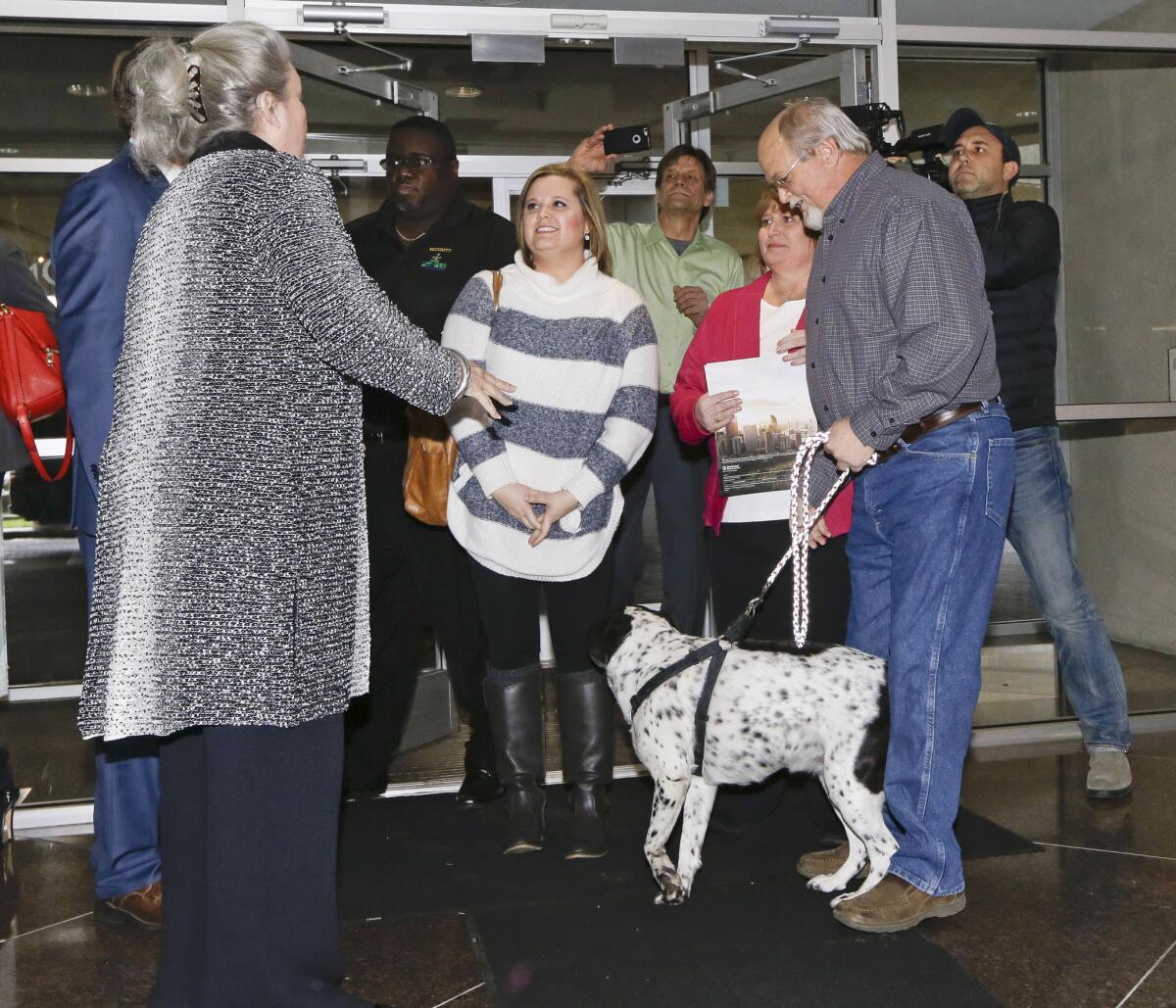 John Robinson, front right, arrives at the Tennessee Lottery headquarters in Nashville on Jan. 15 with his wife, Lisa; daughter, Tiffany, center, and family dog on Jan. 15.