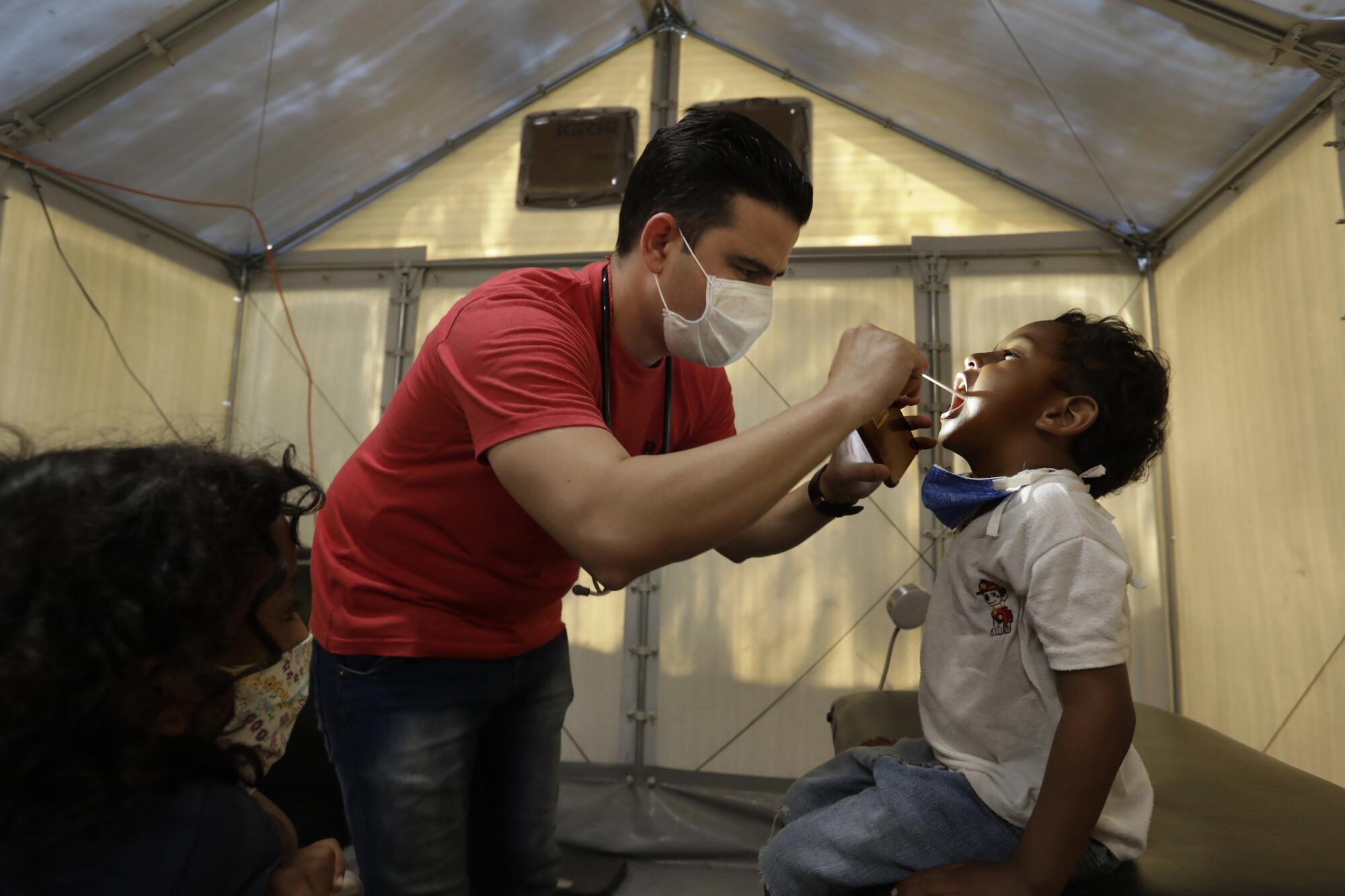 Cuban physician Lestter Guerra treats Angel Gabriel Recinos, 5.