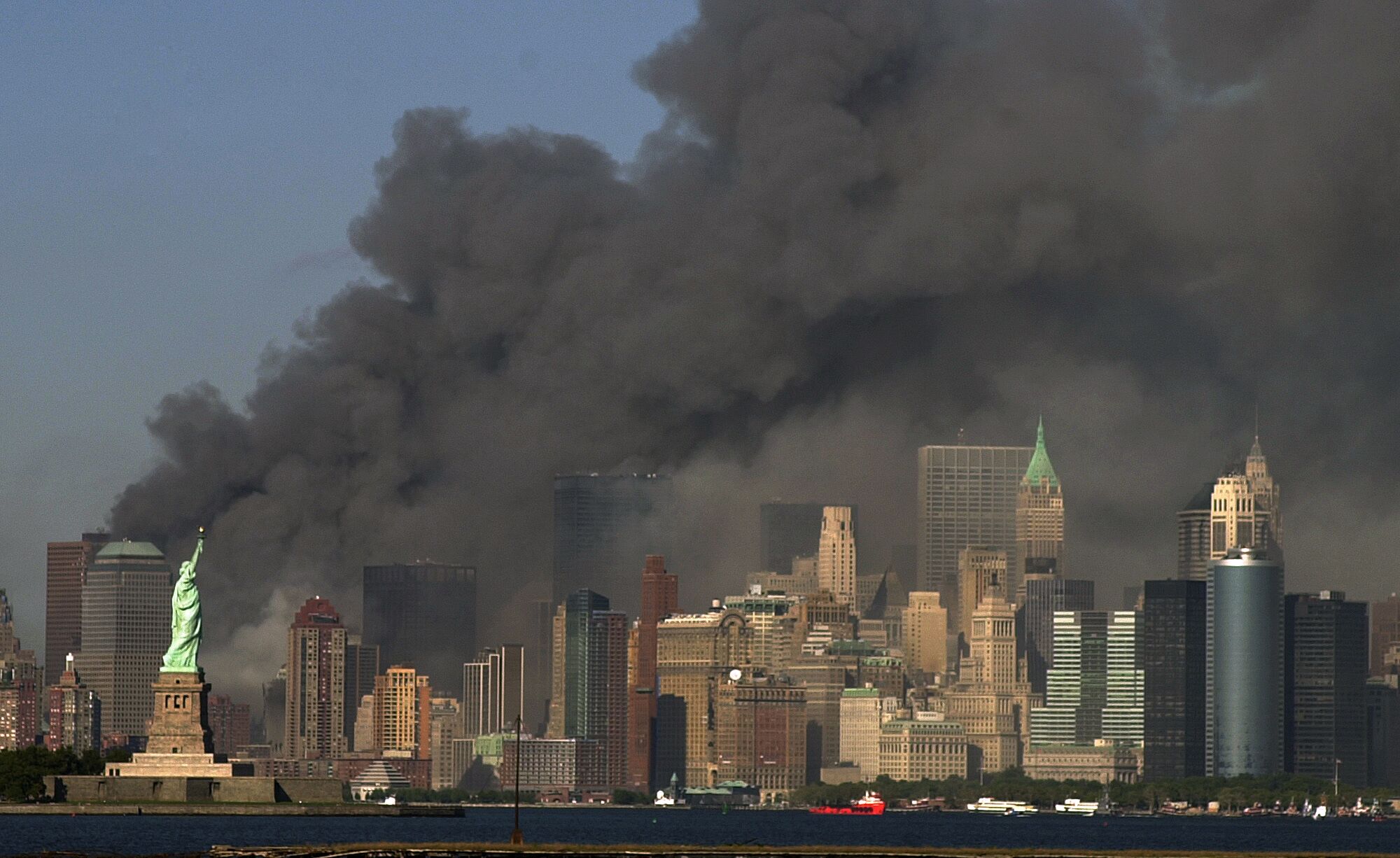 With the Statue of Liberty at left, the smoking Manhattan skyline after the attacks