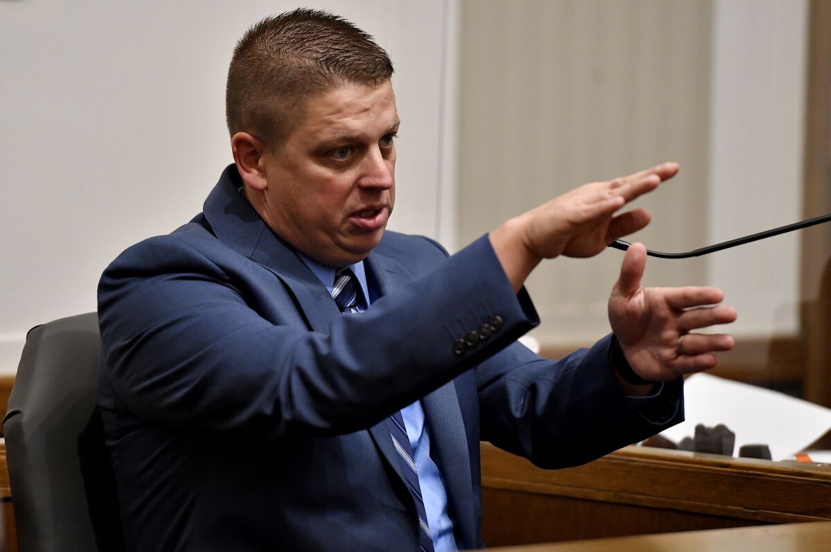 Eric DeValkenaere, a Kansas City, Mo., police detective, who shot and killed Cameron Lamb after a chase, testified Wednesday, Nov. 10, 2021, at the Jackson County Courthouse in Kansas City, Mo., about what led up to the shooting of Lamb, who was backing his pickup truck into his garage. (Rich Sugg/The Kansas City Star via AP)
