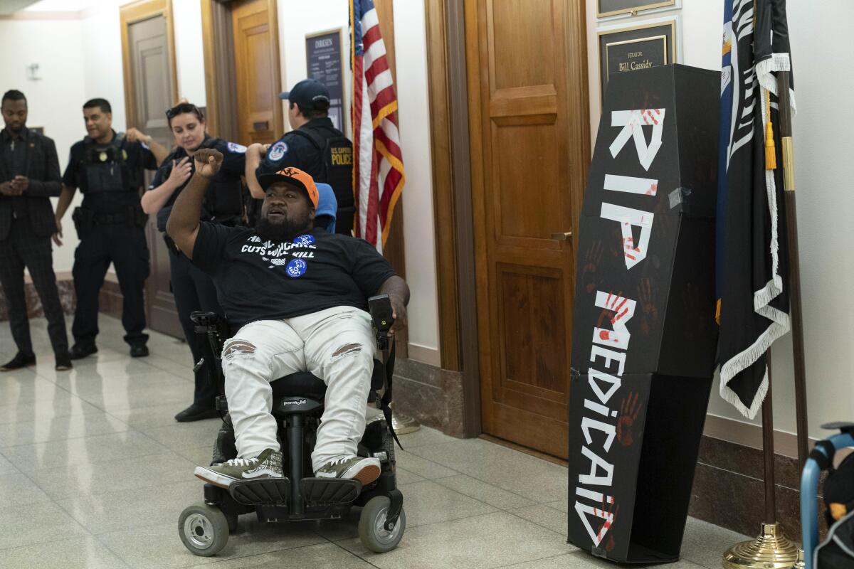A demonstrator in a wheelchair protests proposed cuts to Medicaid on Capitol Hill on June 11.