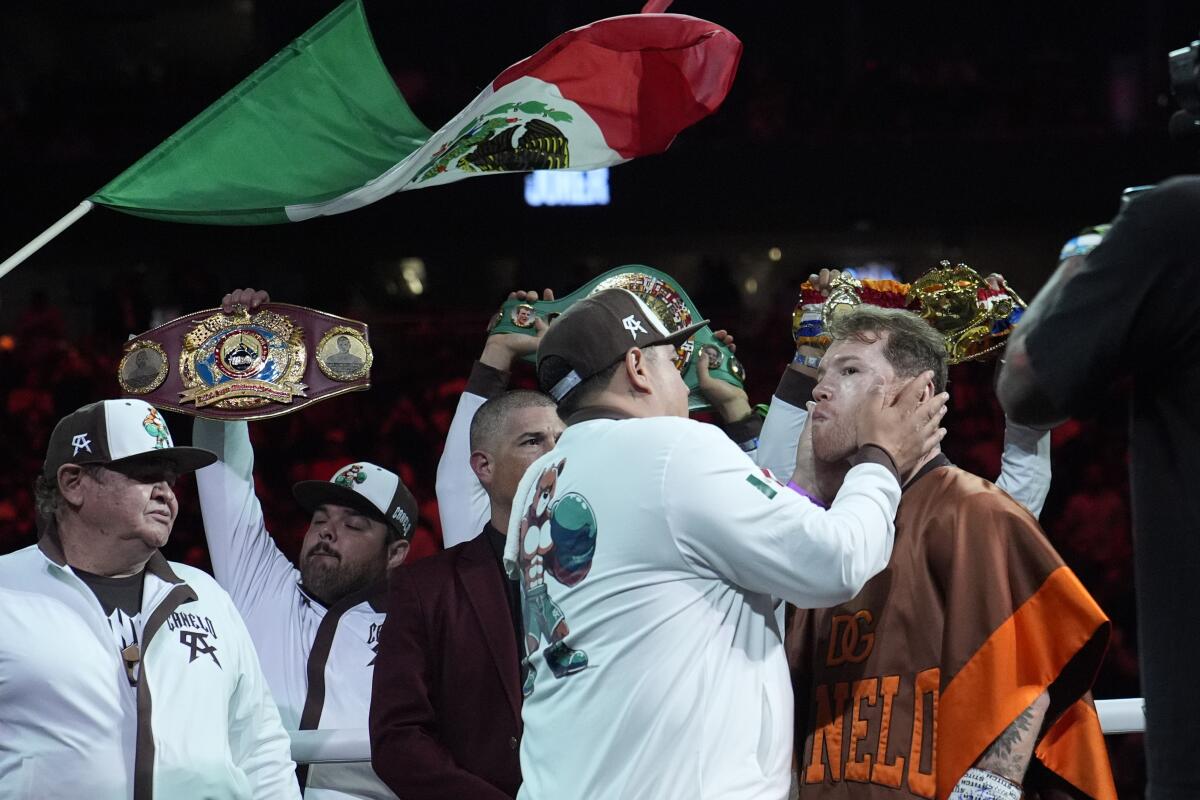 Canelo Alvarez, right, prepares before fighti 