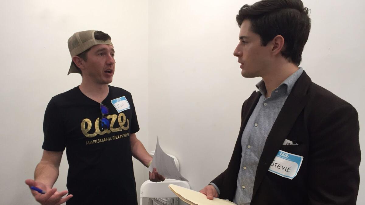 Drew Rothe, left, who is recruiting drivers for the cannabis delivery service Eaze, chats with Stevie Ray-Vance, who recently moved to L.A. from Denver, and is looking to break into the cannabis industry