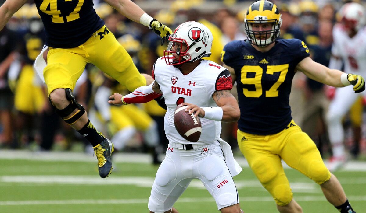 Utah quarterback Kendal Thompson tries to evade the rush of Michigan's defense during their game last weekend.