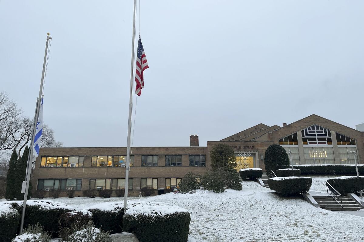 A menorah stands outside the entrance to Temple Israel in Albany, N.Y.