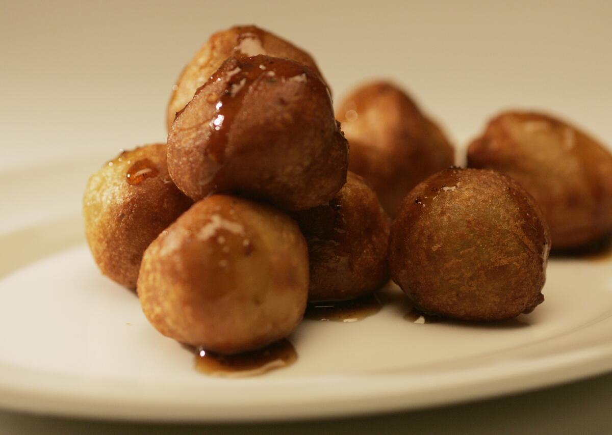 An elegant mound of tiny Cabrales blue cheese beignets drizzled with a peppery honey gastrique.