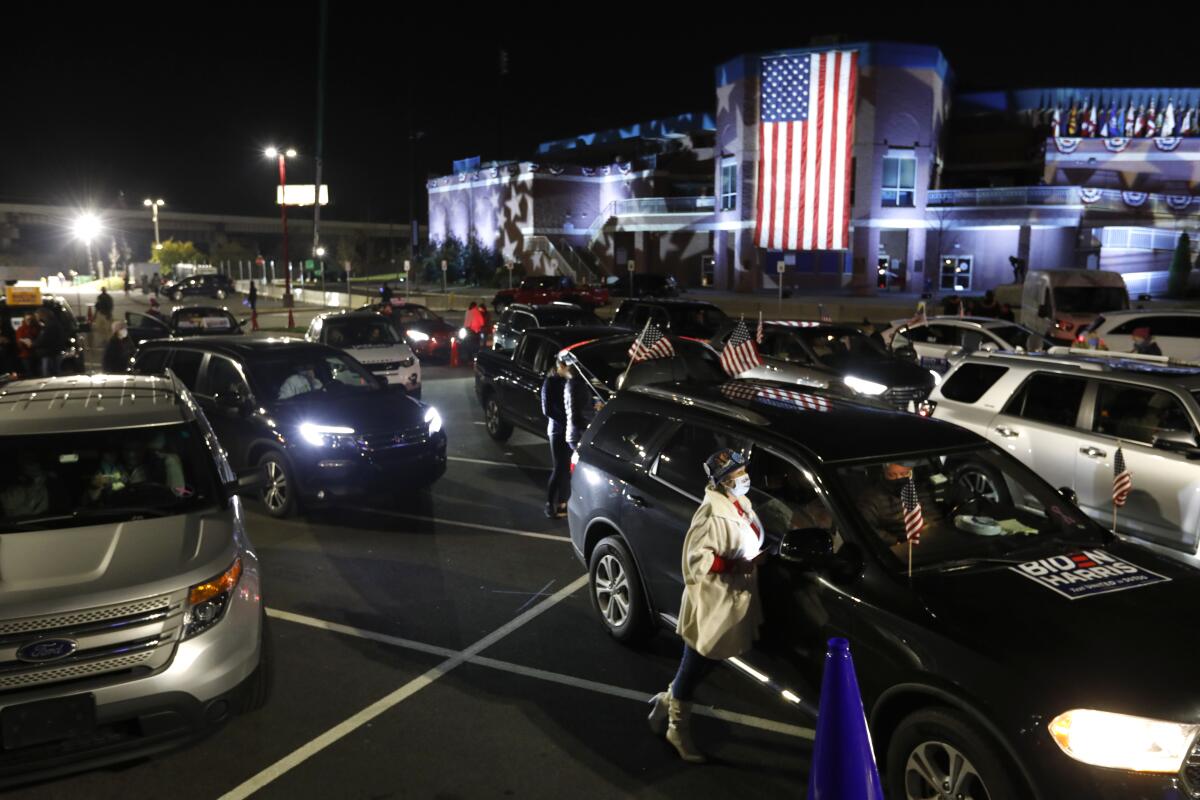 \Supporters wait for Democratic nominee  Joe Biden and Senator Kamala Harris make their final statements at a drive-in rally.