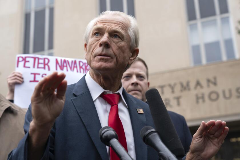 Former Trump White House official Peter Navarro talks to the media as he leaves the U.S. Federal Courthouse in Washington, Thursday, Jan. 25, 2024. Navarro, who was convicted of contempt of Congress for refusing to cooperate with a congressional investigation into the Jan. 6, 2021, attack on the U.S. Capitol, and sentenced on Thursday to four months behind bars. (AP Photo/Jose Luis Magana)