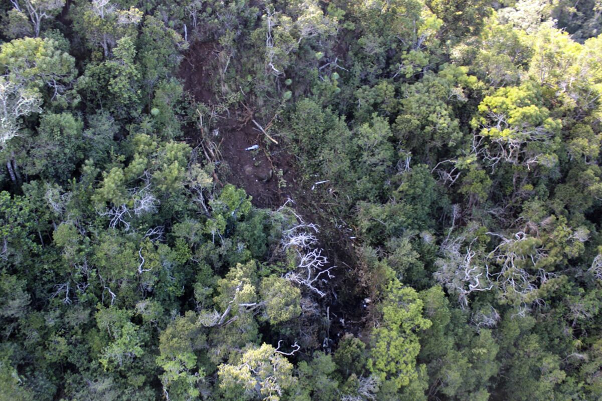 FILE — This undated photo provided by the National Transportation Safety Board shows the scene where a tour helicopter crashed near the Na Pali Coast on the island of Kauai in Hawaii, in 2019. Federal accident investigators blamed a deadly tour helicopter crash in Hawaii on the pilot's decision to keep flying into worsening weather, but they saved their sharpest criticism for regulators whom they accused of lax oversight of tour flights in the islands. The National Transportation Safety Board determination on Tuesday, May 10, 2022, followed an investigation into the Dec. 2019 helicopter crash that killed all seven people on board. (National Transportation Safety Board via AP, File)