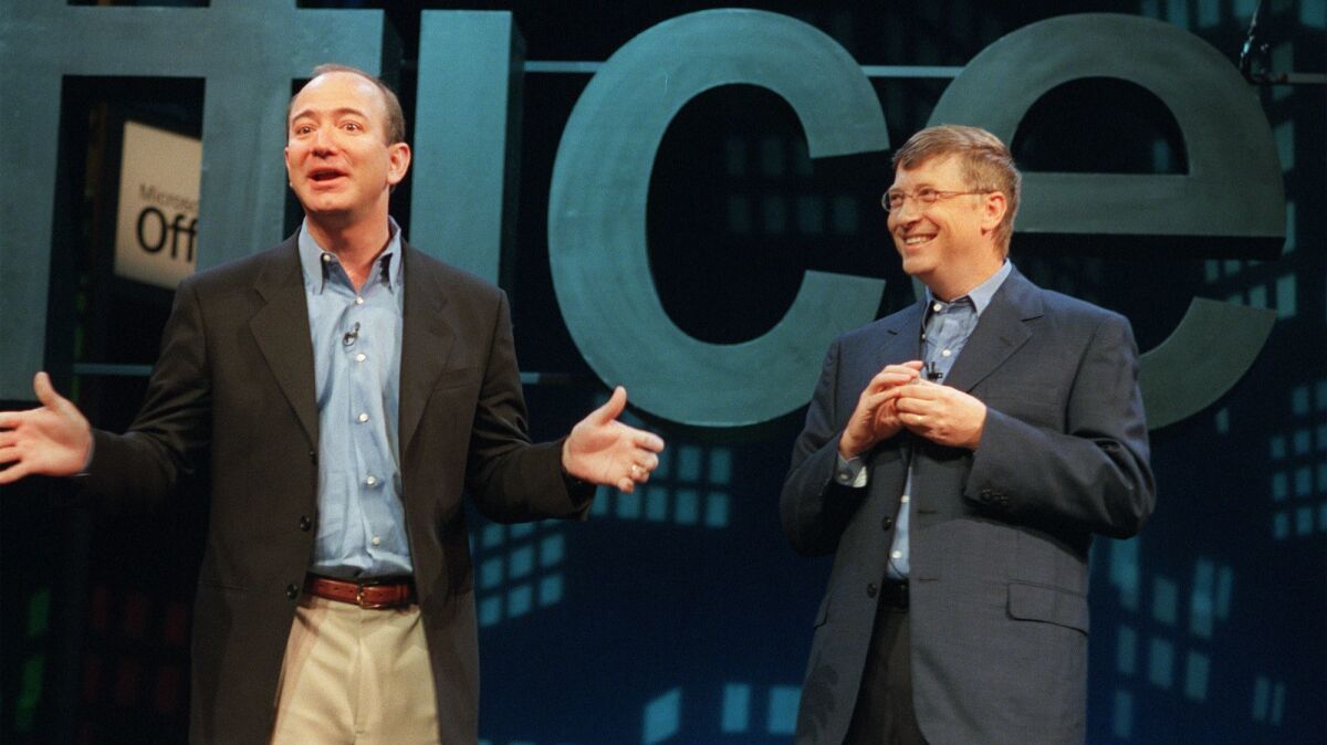 Jeff Bezos, founder of Amazon.com, left, meets with Microsoft founder Bill Gates at a New York news conference on May 31, 2001.