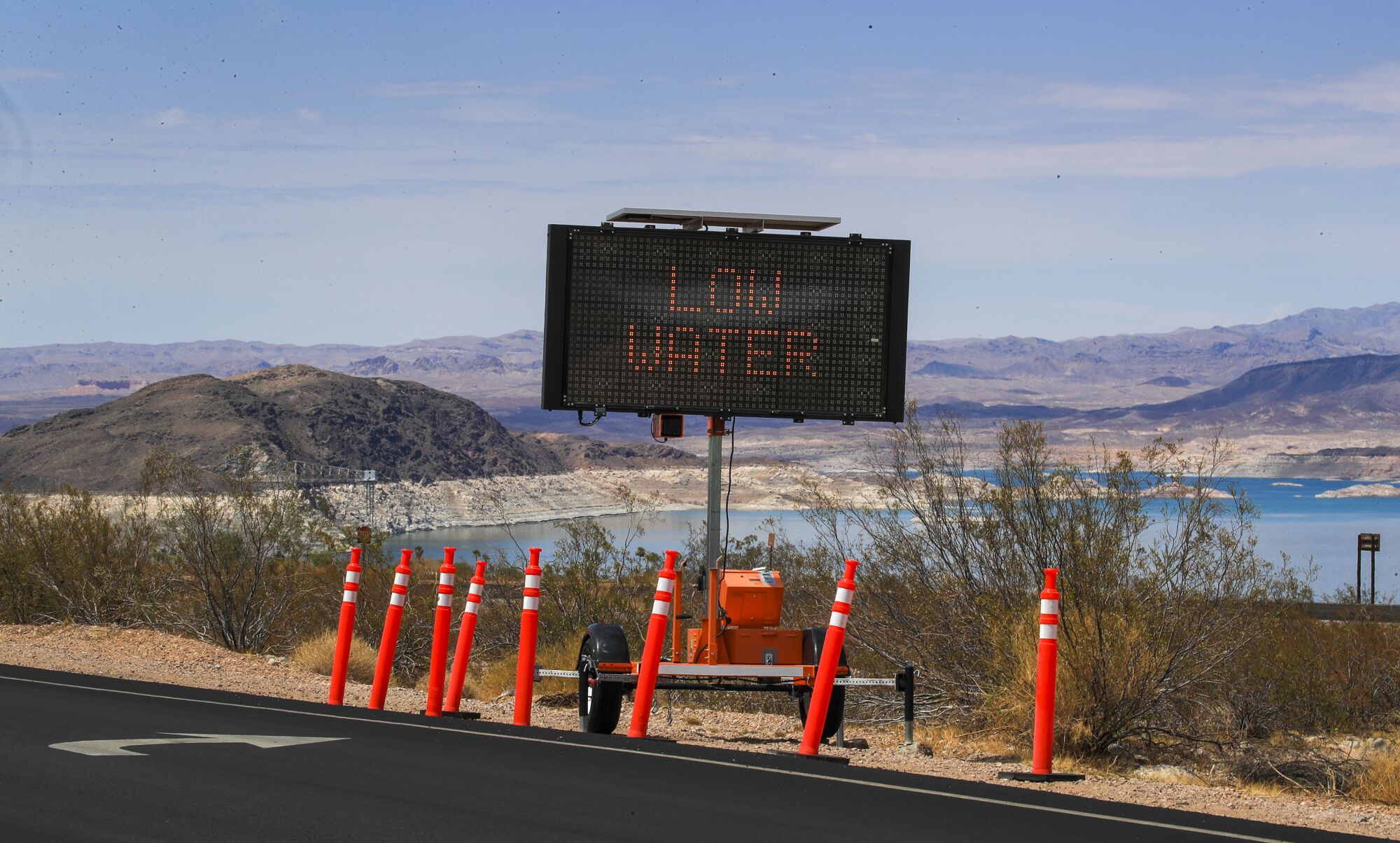 An electronic roadside sign says "low water"