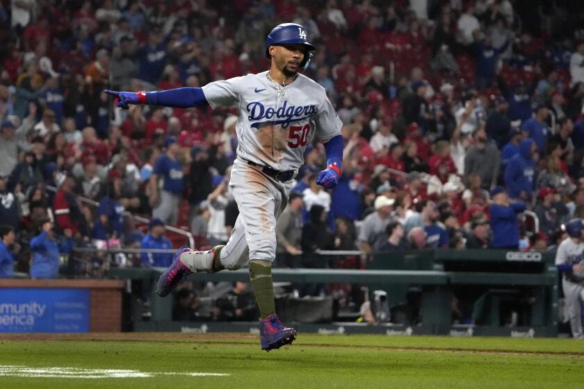 The Dodgers' Mookie Betts celebrates after he hit a three-run home run in the eighth inning May 19, 2023, in St. Louis.