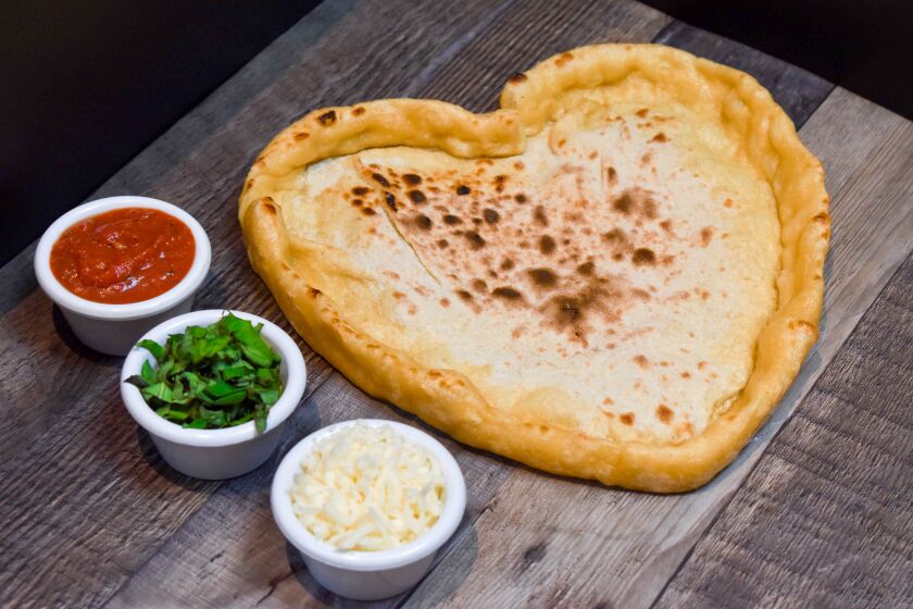 Sammy's Woodfired Pizza is warming our hearts with this heart-shaped pizza kit, with pre-baked crust, tomato sauce, mozzarella and basil. 