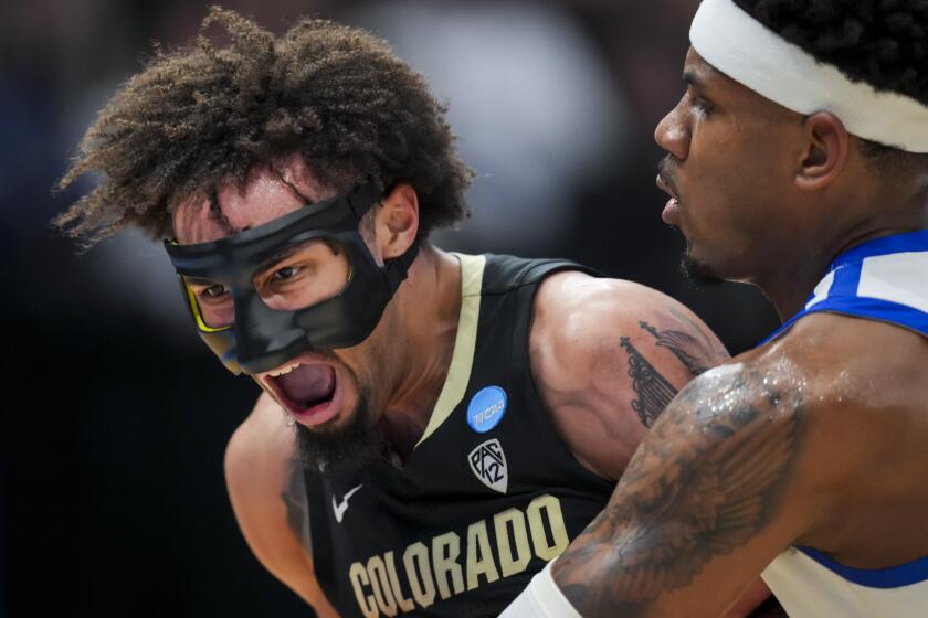 Colorado guard J'Vonne Hadley, left, reacts after colliding with Boise State guard Chibuzo Agbo, right, during the second half of a First Four game in the NCAA men's college basketball tournament Wednesday, March 20, 2024, in Dayton, Ohio. (AP Photo/Aaron Doster)