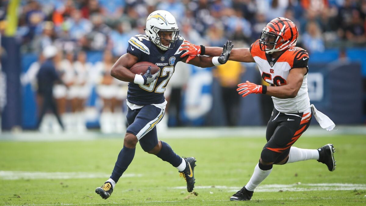 Running back Justin Jackson of the Chargers makes a play against middle linebacker Hardy Nickerson of the Cincinnati Bengals for a first down in the first quarter at StubHub Center.