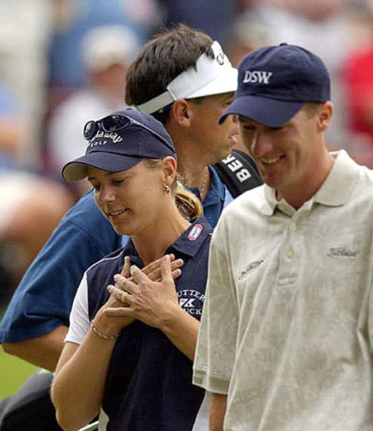 Annika Sorenstam walks off the 13th green with playing partner Aaron Barber, right, and her caddie Terry McNamara after making a birdie at the Colonial Country Club in Fort Worth, Texas, in 2003. 
