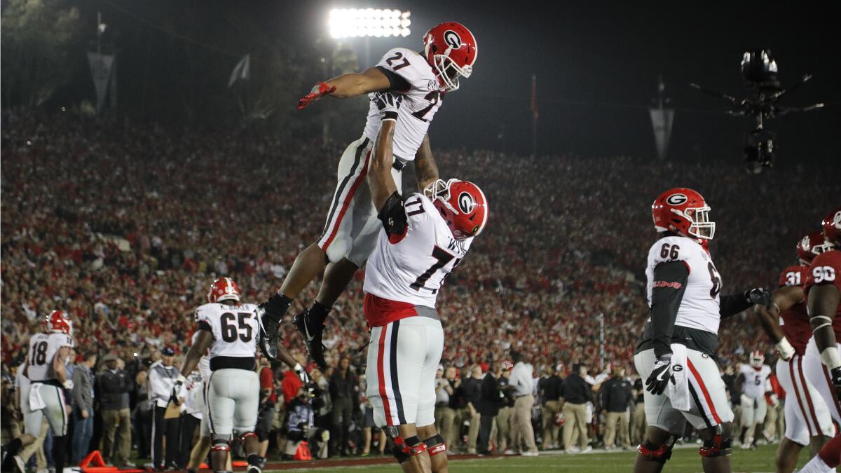 Bulldogs running back Nick Chubb is lifted up by offensive tackle Isaiah Wynn after scoring the tying touchdown in the fourth quarter of the Rose Bowl on Jan. 1.