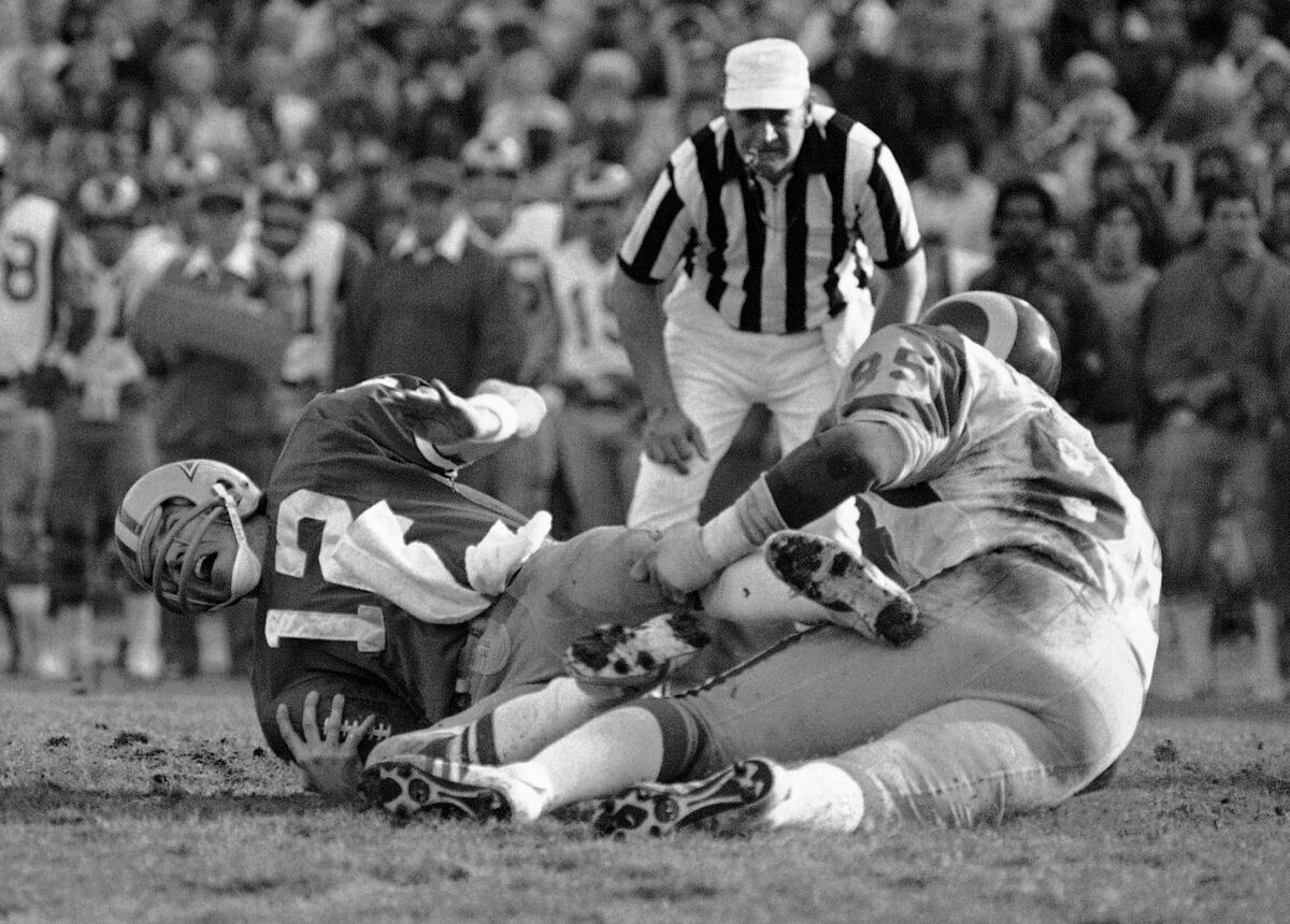 Le quart-arrière des Cowboys Roger Staubach est limogé par Jack Youngblood des Rams lors du match de championnat NFC en 1979. 