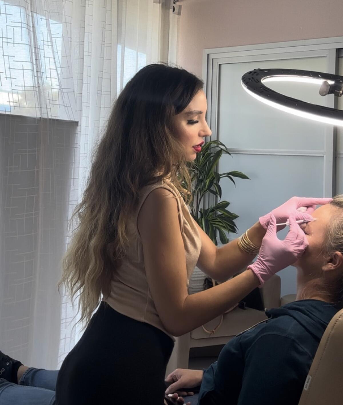 Inject Me SD owner Brenna Derakshan treats a client at her Bird Rock location.