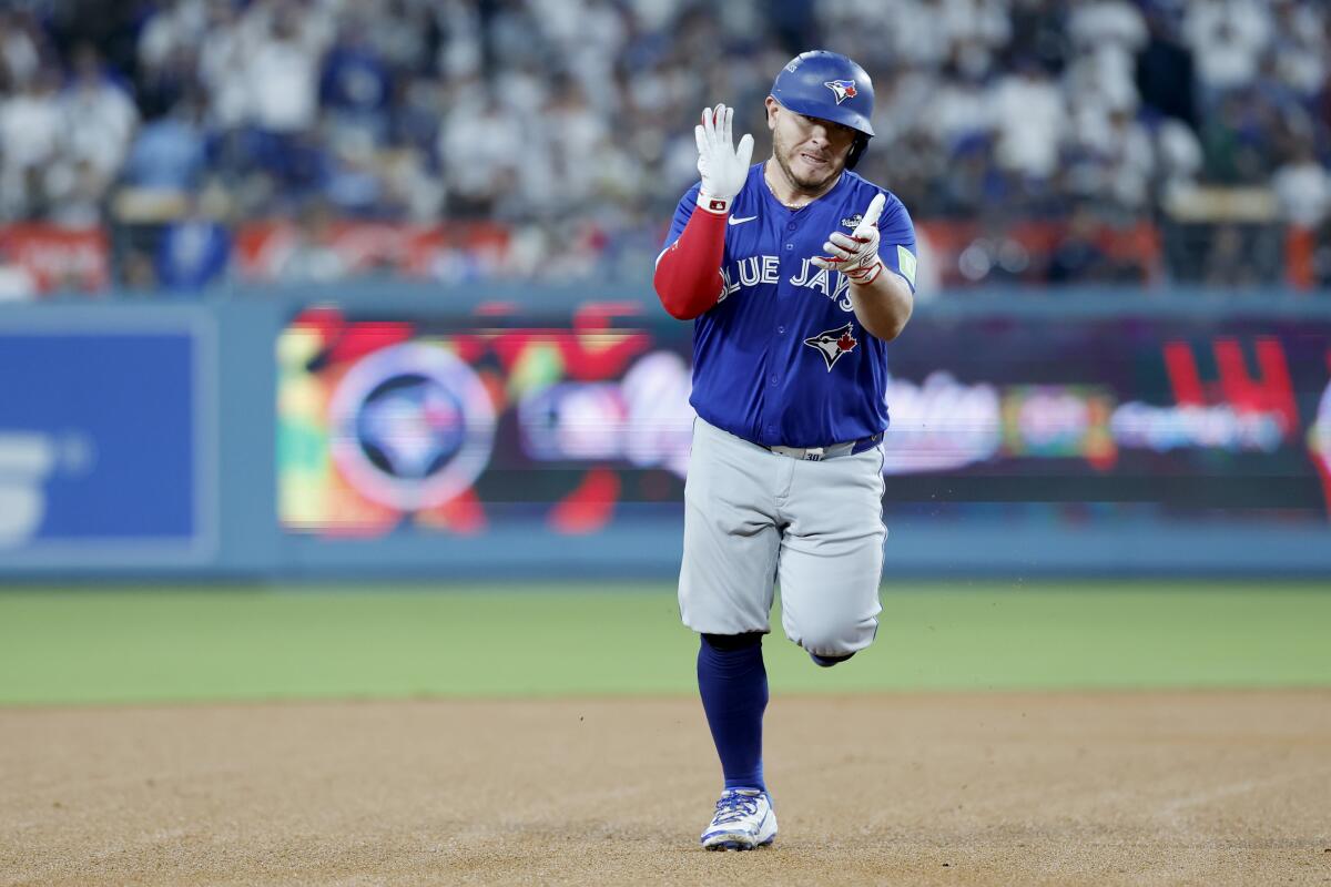 Toronto Blue Jays catcher Alejandro Kirk celebrates after hitting a three-run home run in the fourth inning.