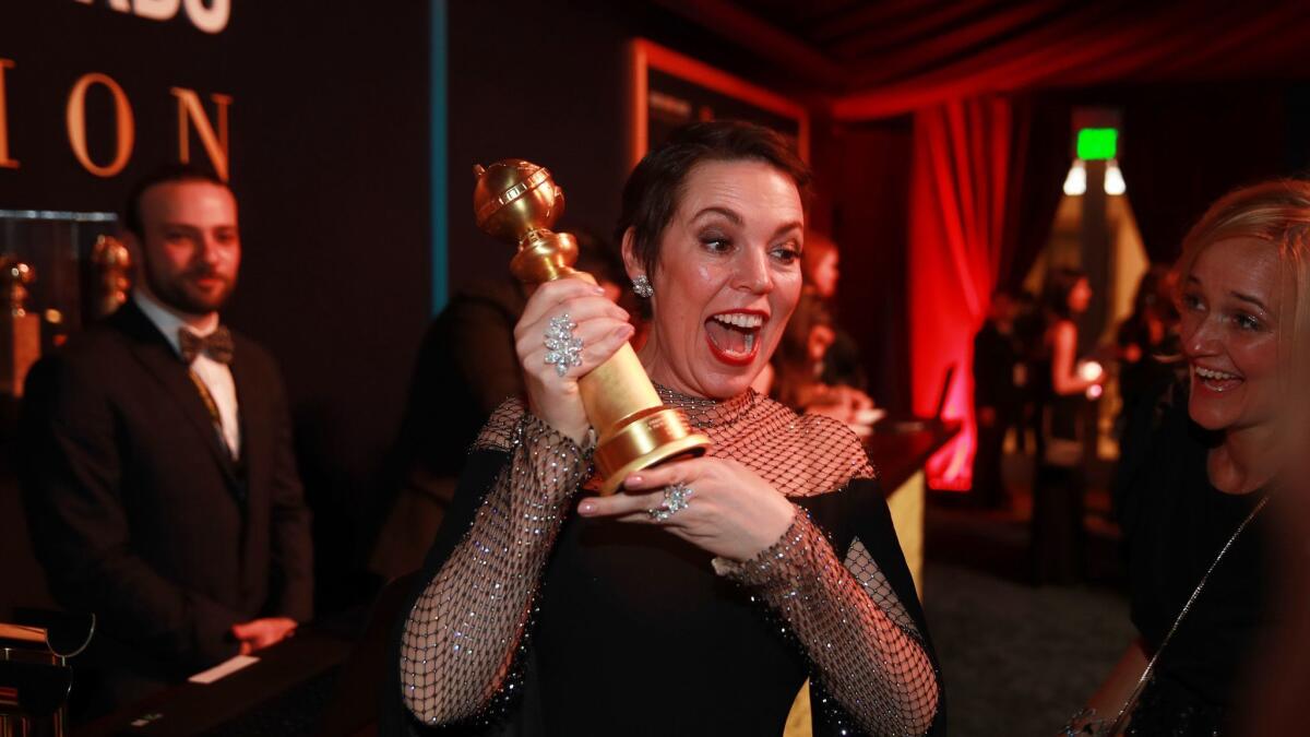 Olivia Colman holds up her Golden Globe for best actress, musical or comedy for "The Favourite" hours after her victory.