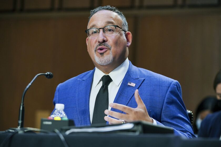 In this Sept. 30, 2021, file photo, Education Secretary Miguel Cardona testifies on Capitol Hill in Washington. The Biden administration is moving to relax the rules for a student loan forgiveness program that has been criticized for its notoriously complex requirements. The change could offer debt relief to thousands of teachers, social workers, military members and other public servants. The Education Department says it will temporarily drop some of the toughest requirements around the program, Public Service Loan Forgiveness, which was launched in 2007 to steer more college graduates into public service. (Greg Nash/Pool via AP)