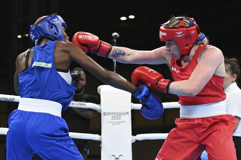 FILE - Northern Ireland's Amy Sara Broadhurst, right, and Nigeria's Cynthia Ogunsemilore, left, compete during the women's light semifinal boxing bout at the Commonwealth Games in Birmingham, England, Aug. 6, 2022. A world champion for Ireland, Broadhurst will try to get to the Paris Olympics fighting for Britain. The 27-year-old Broadhurst switched allegiance after not being selected by Ireland for the final Olympic qualifier in Bangkok. (AP Photo/Rui Vieira, File)