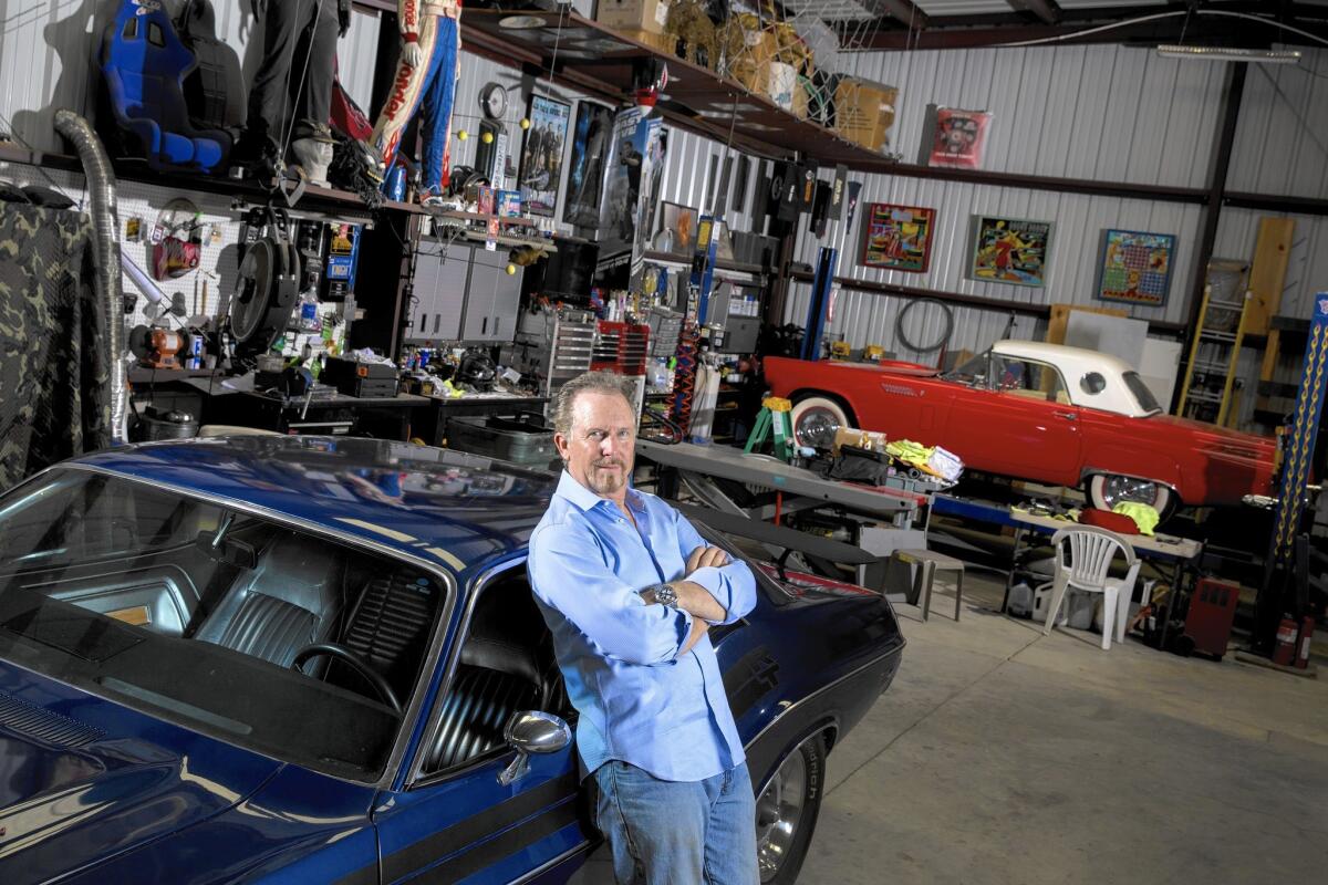 Veteran stuntman Jack Gill inside his workshop, with his 1971 Dodge Challenger RT and an assortment of collectibles from various film and TV projects, in Agoura Hills, Calif., on June 16, 2015.