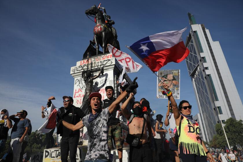 Anti-government protesters chant against President Sebastian Pinera in Santiago, Chile, Wednesday, Oct. 30, 2019. Pinera cancelled two major international summits after nearly two weeks of nationwide protests over economic inequality that have left at least 20 dead and damaged businesses and infrastructure around the country.(AP Photo/Rodrigo Abd)