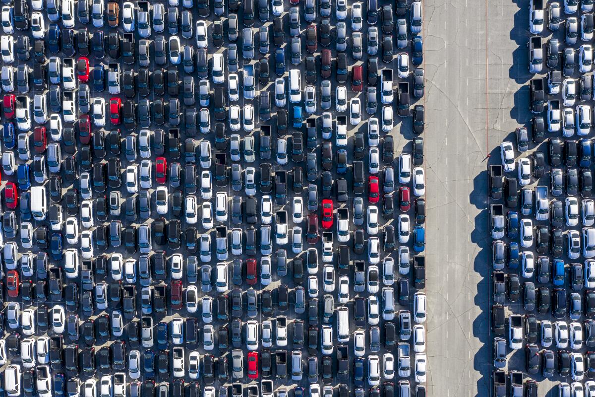 An aerial photo of many lines of parked cars