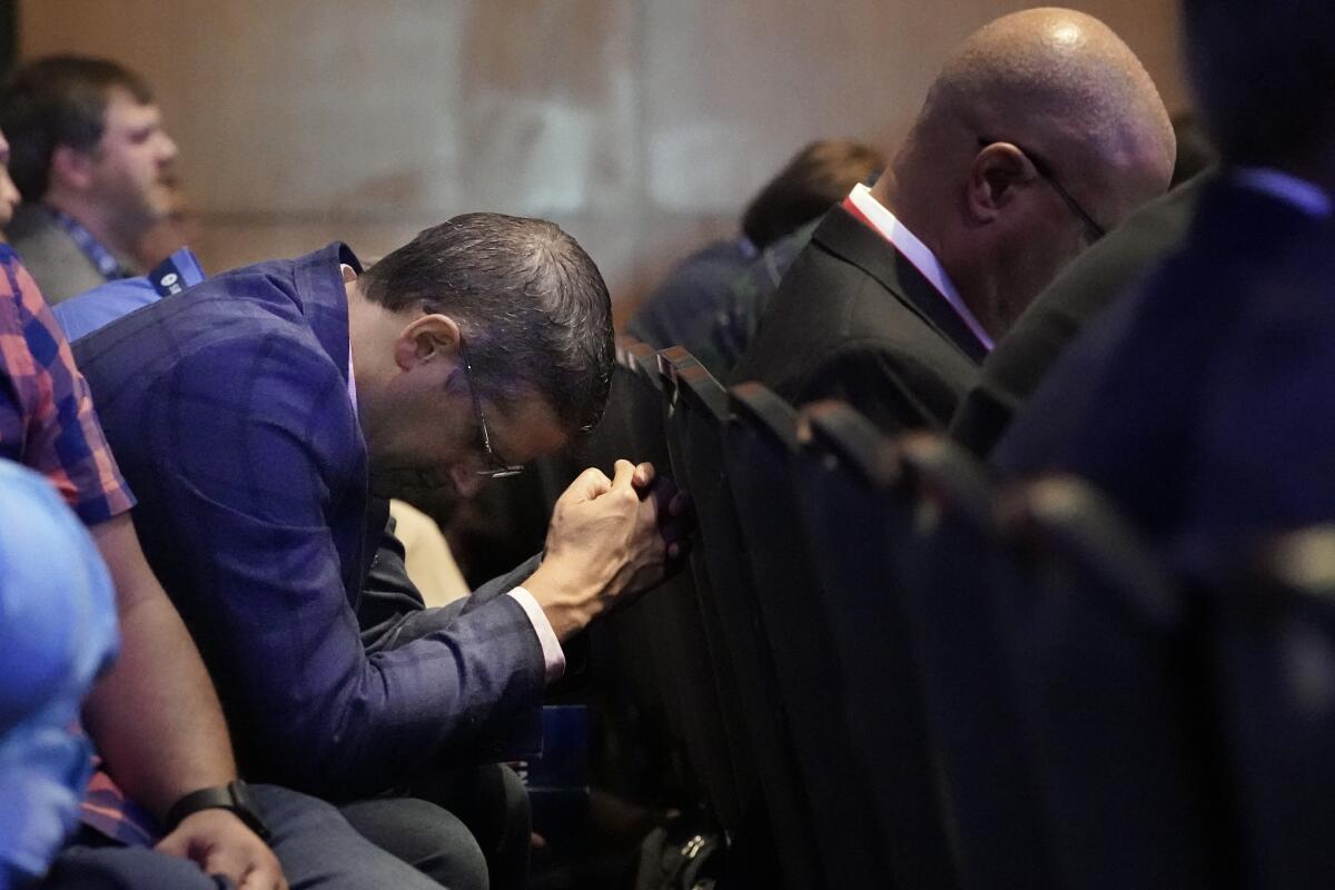 A man prays during the executive committee plenary meeting at the Southern Baptist Convention's annual meeting Monday, June 14, 2021, in Nashville, Tenn. (AP Photo/Mark Humphrey)