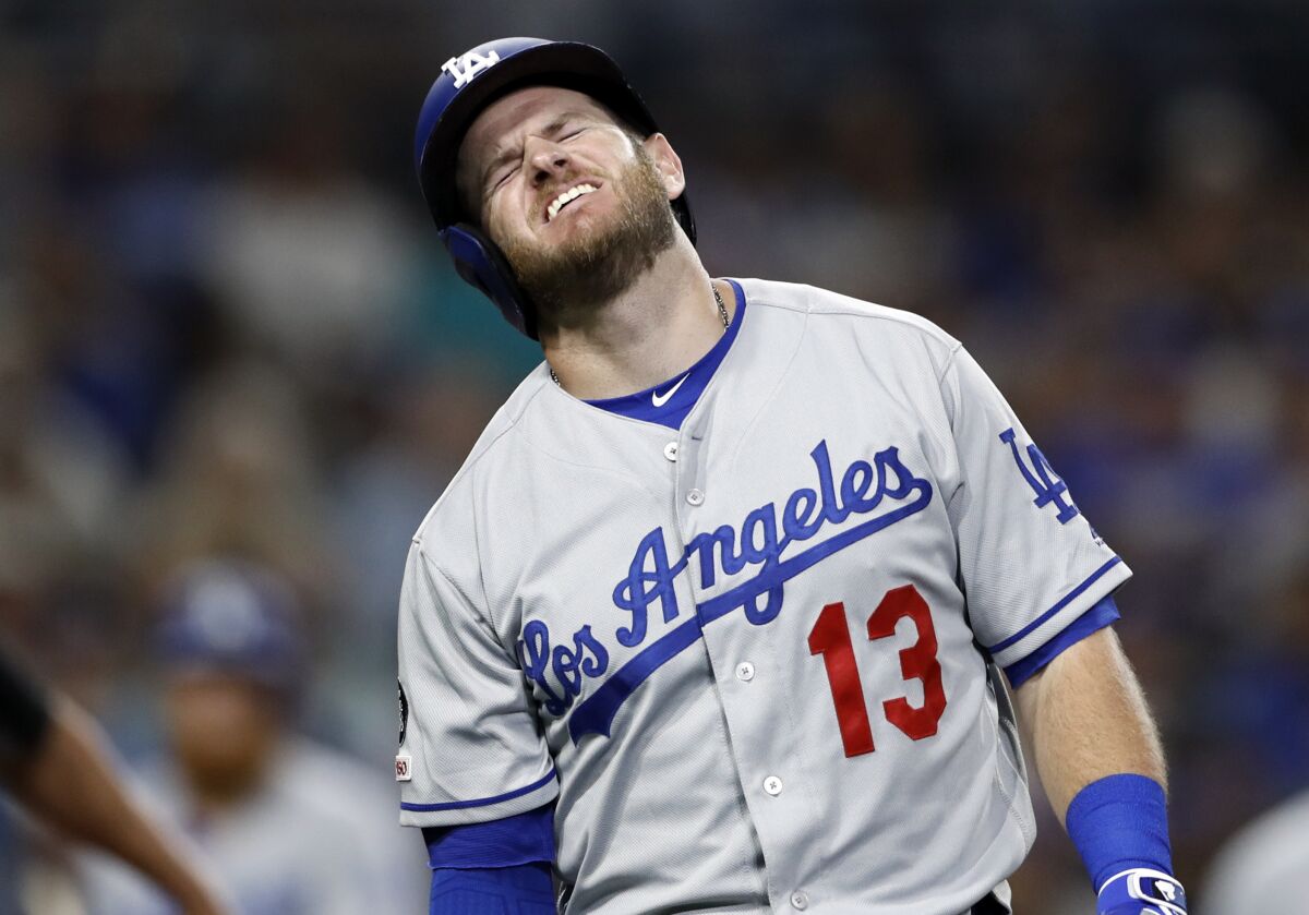 Dodgers' Max Muncy reacts after being hit on the arm while batting against the San Diego Padres on Aug. 28.